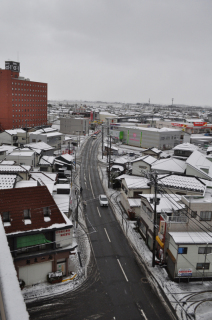 民家の屋根がうっすらと雪化粧＝2日午前9時、鶴岡市末広町の鶴岡パークビル