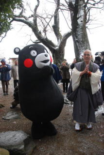 くまモンが鶴岡市丸岡の天澤寺を訪れ、庄司住職（右）と一緒に清正閣の前で手を合わせた