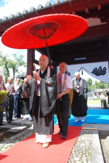 冷岩寺の山門に到着した福山諦法禅師。僧侶や信徒たちが出迎えた